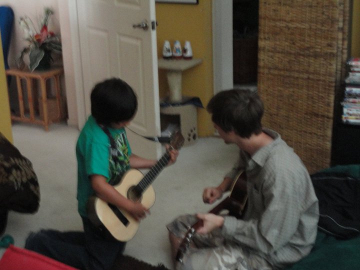 Young Julian with guitar